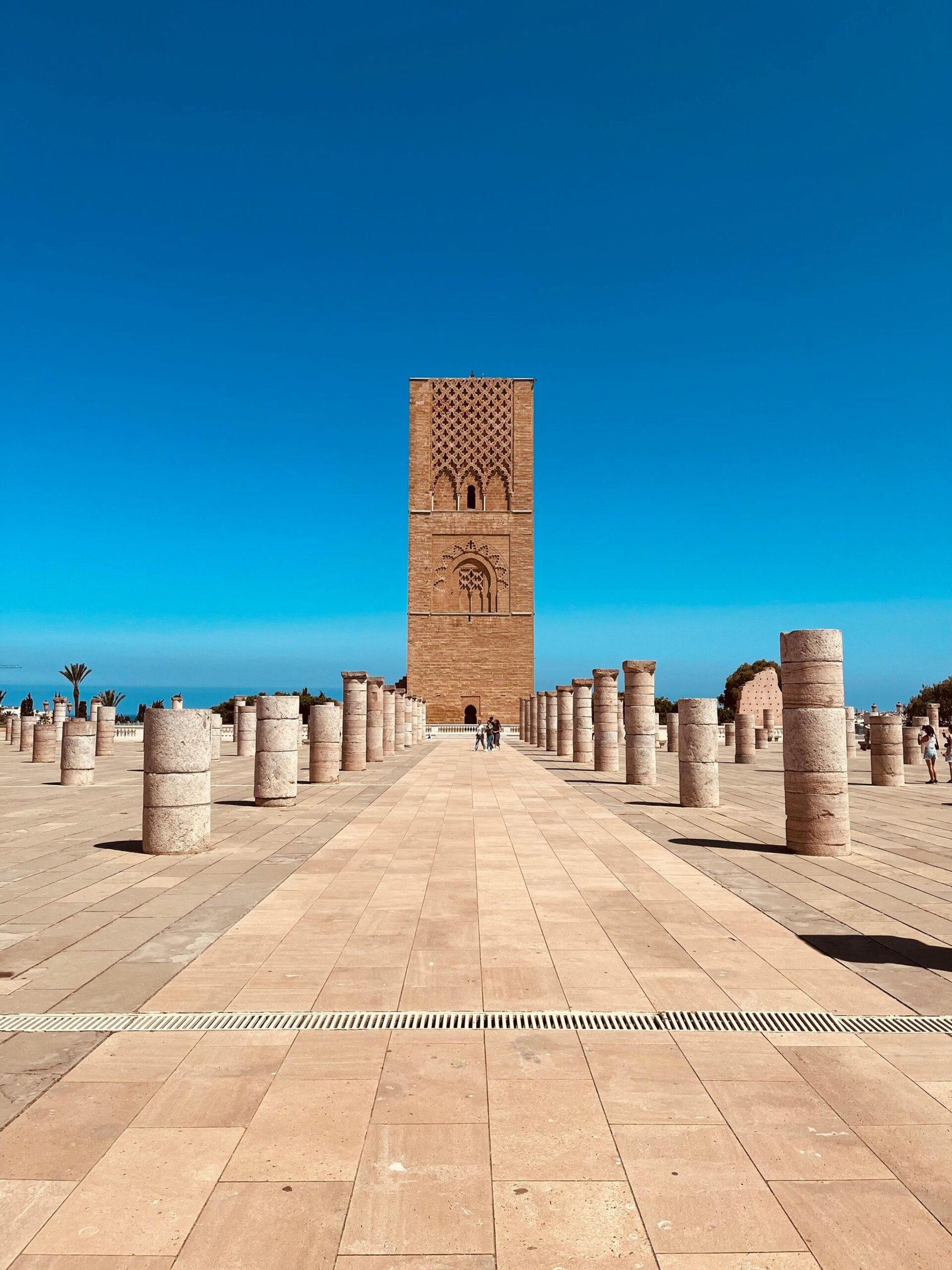 Scenic view of Hassan Tower surrounded by columns in Rabat, Morocco under a clear blue sky.