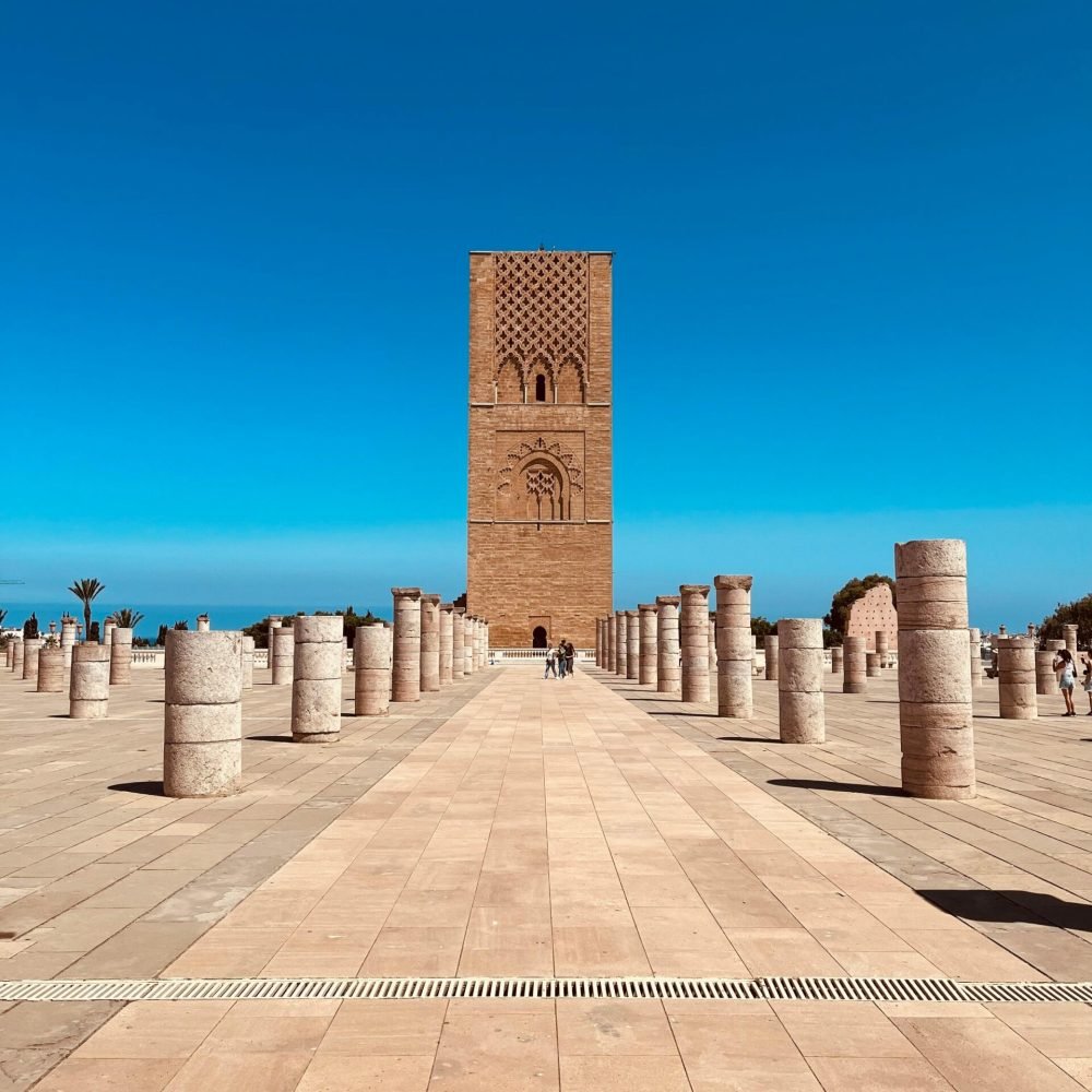 Scenic view of Hassan Tower surrounded by columns in Rabat, Morocco under a clear blue sky.